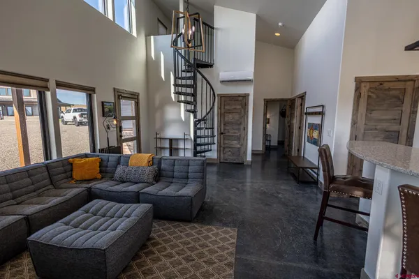 a living room with furniture ceiling fan and a rug