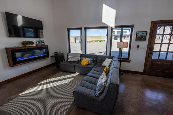 a living room with fireplace furniture and a flat screen tv