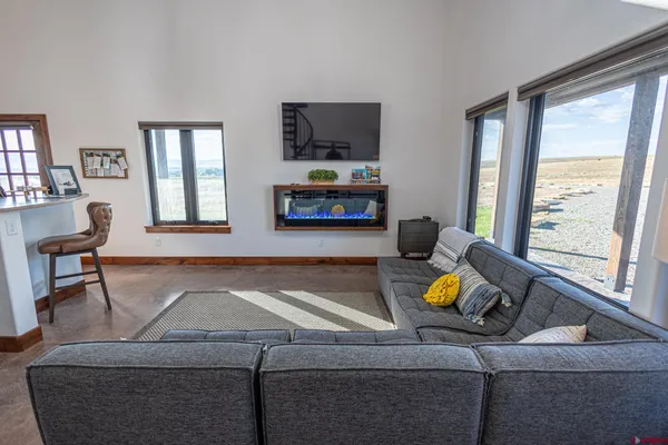 a kitchen with stainless steel appliances a dining table chairs and refrigerator