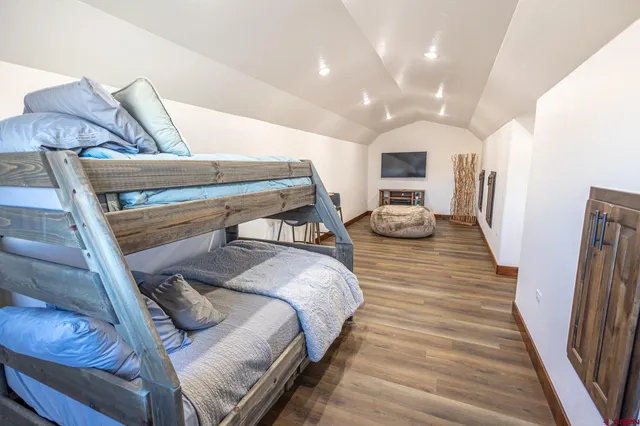 a bedroom with a bed and a mirror