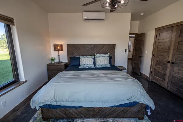 a bedroom with a bed and a window