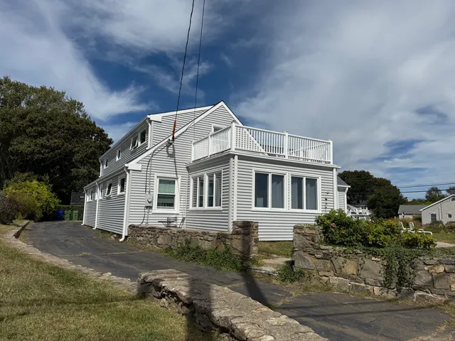 a backyard of a house with yard garage and outdoor seating