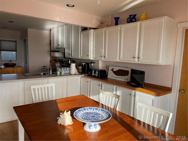 1 Fenwood Drive Old Saybrook, CT 06475 - Photo 5 of 15 a kitchen with stainless steel appliances granite countertop a sink a stove a refrigerator a washer and dryer with wooden floor