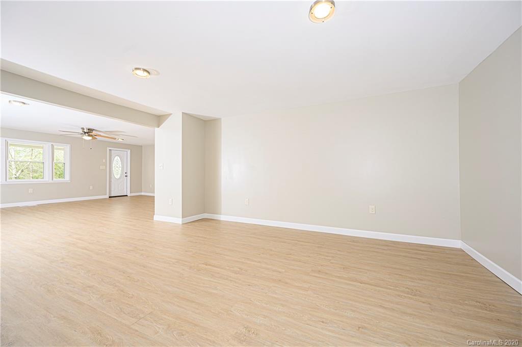 1526 Junction Road Mocksville, NC 27028 - Photo 12 of 28 a view of an empty room with wooden floor and windows