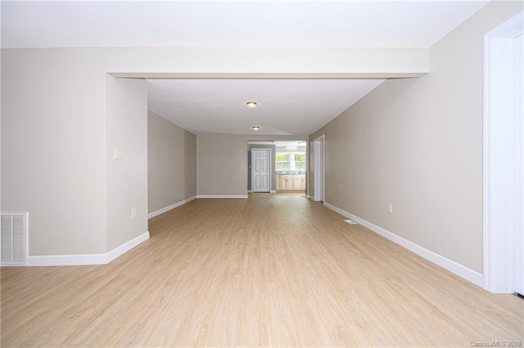 1526 Junction Road Mocksville, NC 27028 - Photo 13 of 28 a view of empty room with wooden floor and fan