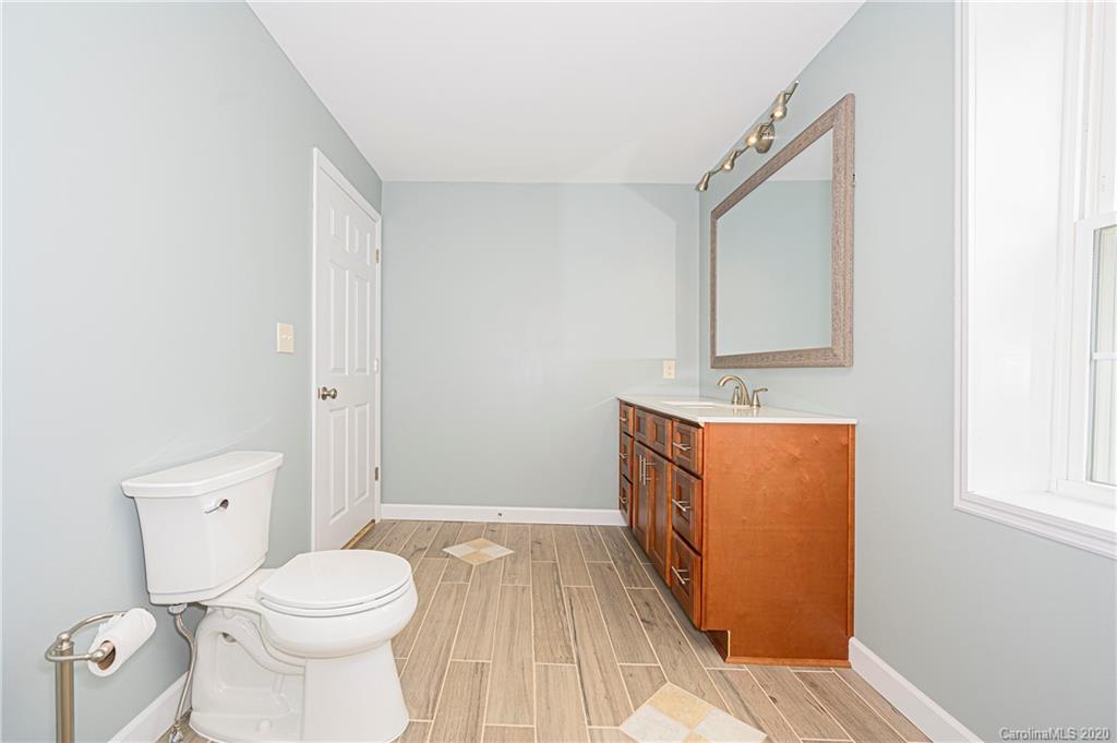 1526 Junction Road Mocksville, NC 27028 - Photo 18 of 28 a bathroom with a sink a toilet and mirror
