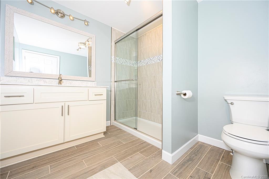 1526 Junction Road Mocksville, NC 27028 - Photo 23 of 28 a bathroom with a toilet sink and a mirror
