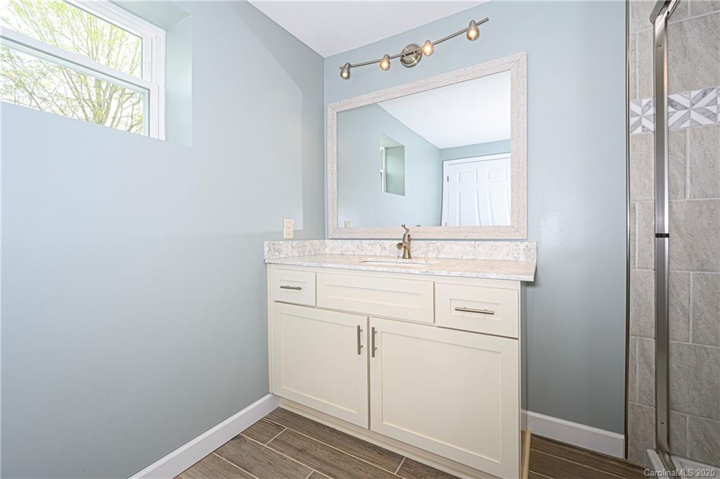 1526 Junction Road Mocksville, NC 27028 - Photo 24 of 28 a bathroom with a sink and a mirror