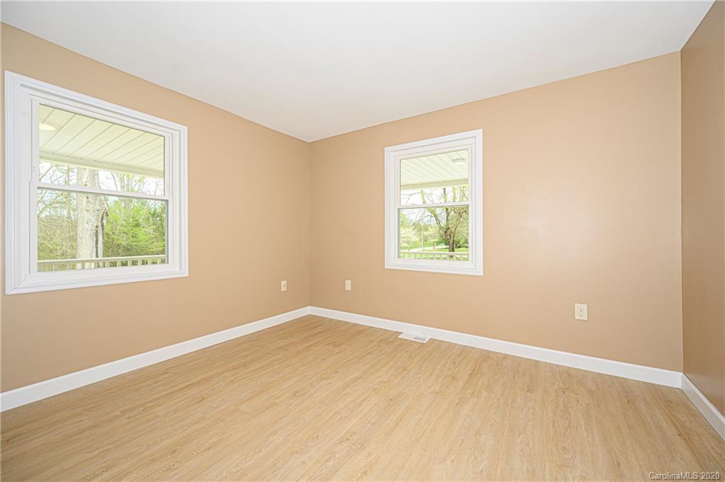 1526 Junction Road Mocksville, NC 27028 - Photo 25 of 28 an empty room with wooden floor and windows