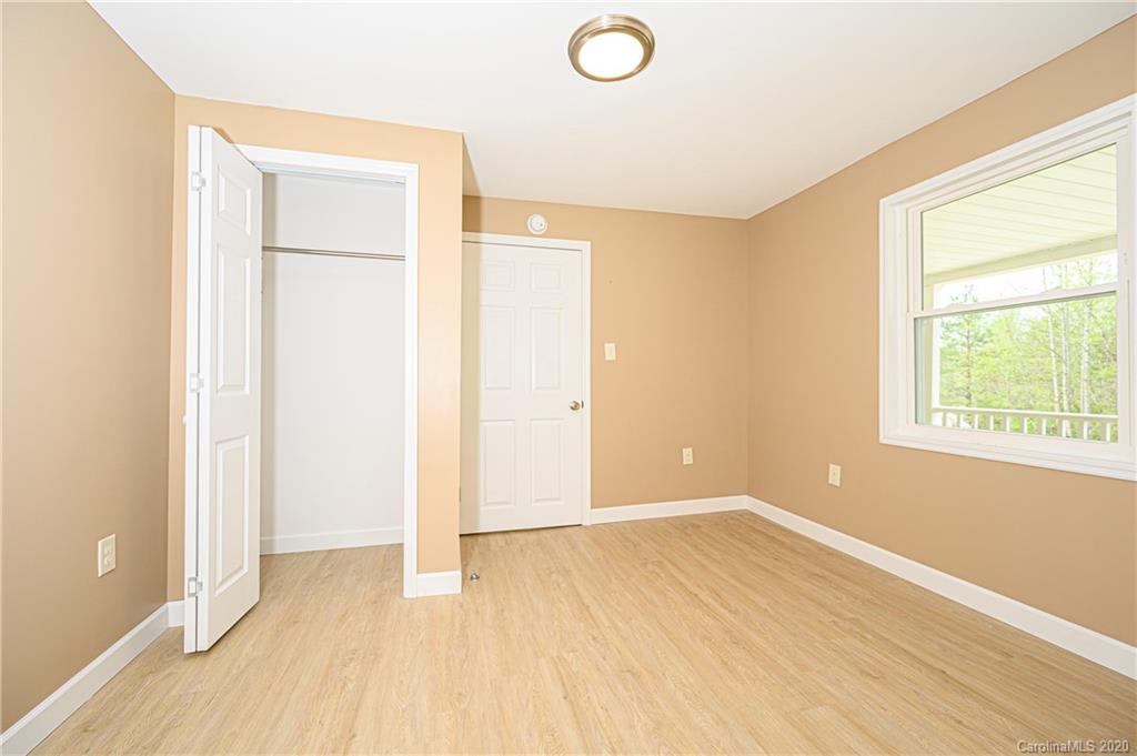 1526 Junction Road Mocksville, NC 27028 - Photo 26 of 28 an empty room with wooden floor and windows