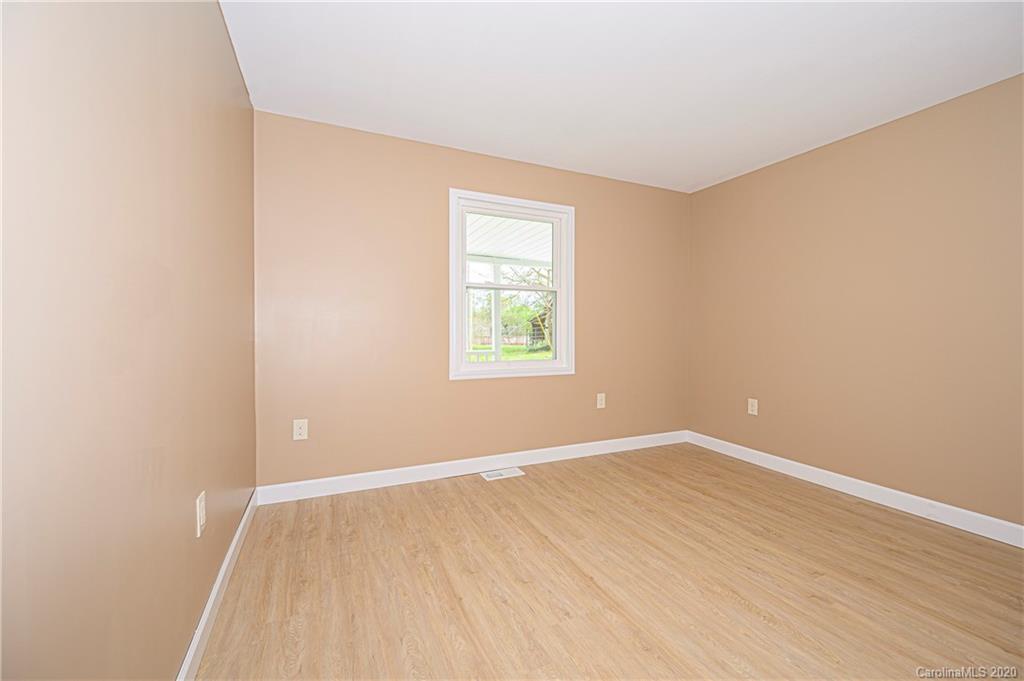 1526 Junction Road Mocksville, NC 27028 - Photo 27 of 28 an empty room with wooden floor and windows
