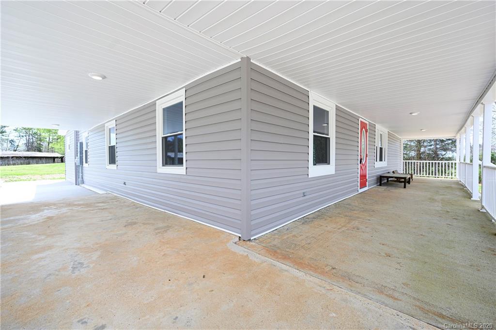 1526 Junction Road Mocksville, NC 27028 - Photo 8 of 28 a view of a house with a backyard and a garage