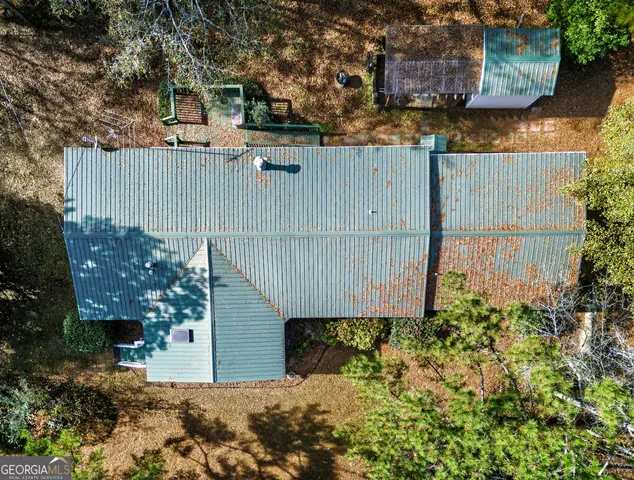 a view of a house with a large tree and a yard