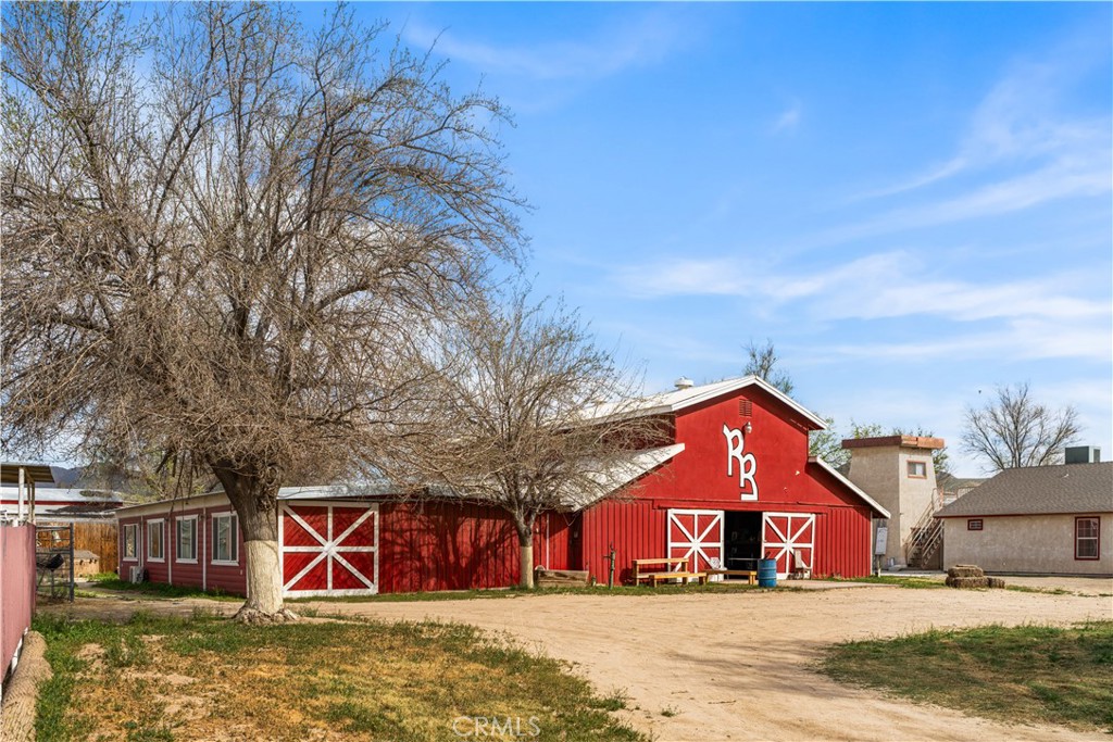14433 Roy Rogers Road Oro Grande, CA 92368 - Photo 20 of 22 a front view of a house with large trees