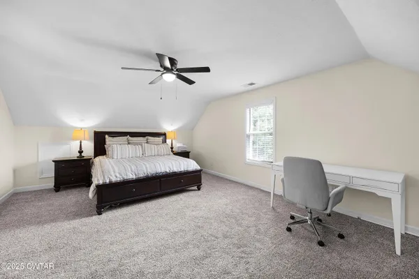 a bedroom with a bed and a chair