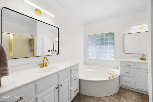 a bathroom with a tub sink and mirror