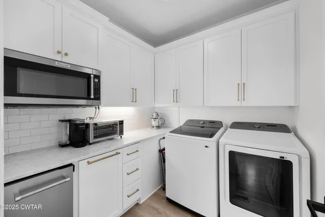 a kitchen with cabinets stainless steel appliances and sink