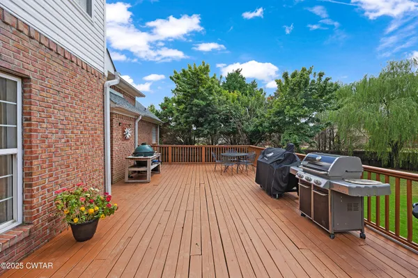 a view of a chairs and table on the wooden deck