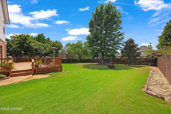 a view of a park with large trees