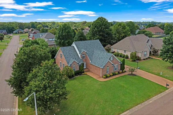 an aerial view of a house with garden space and street view