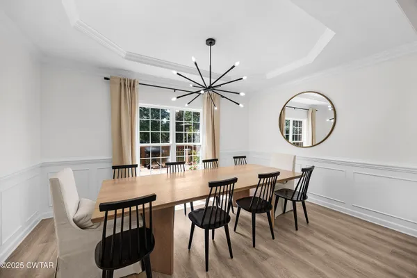 a view of a dining room with furniture and a large window