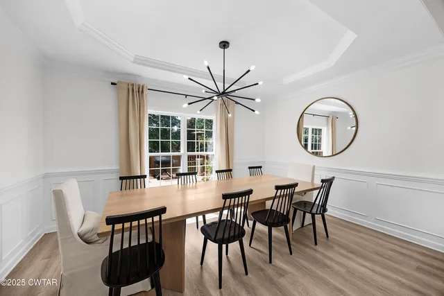 a view of a dining room with furniture and a large window