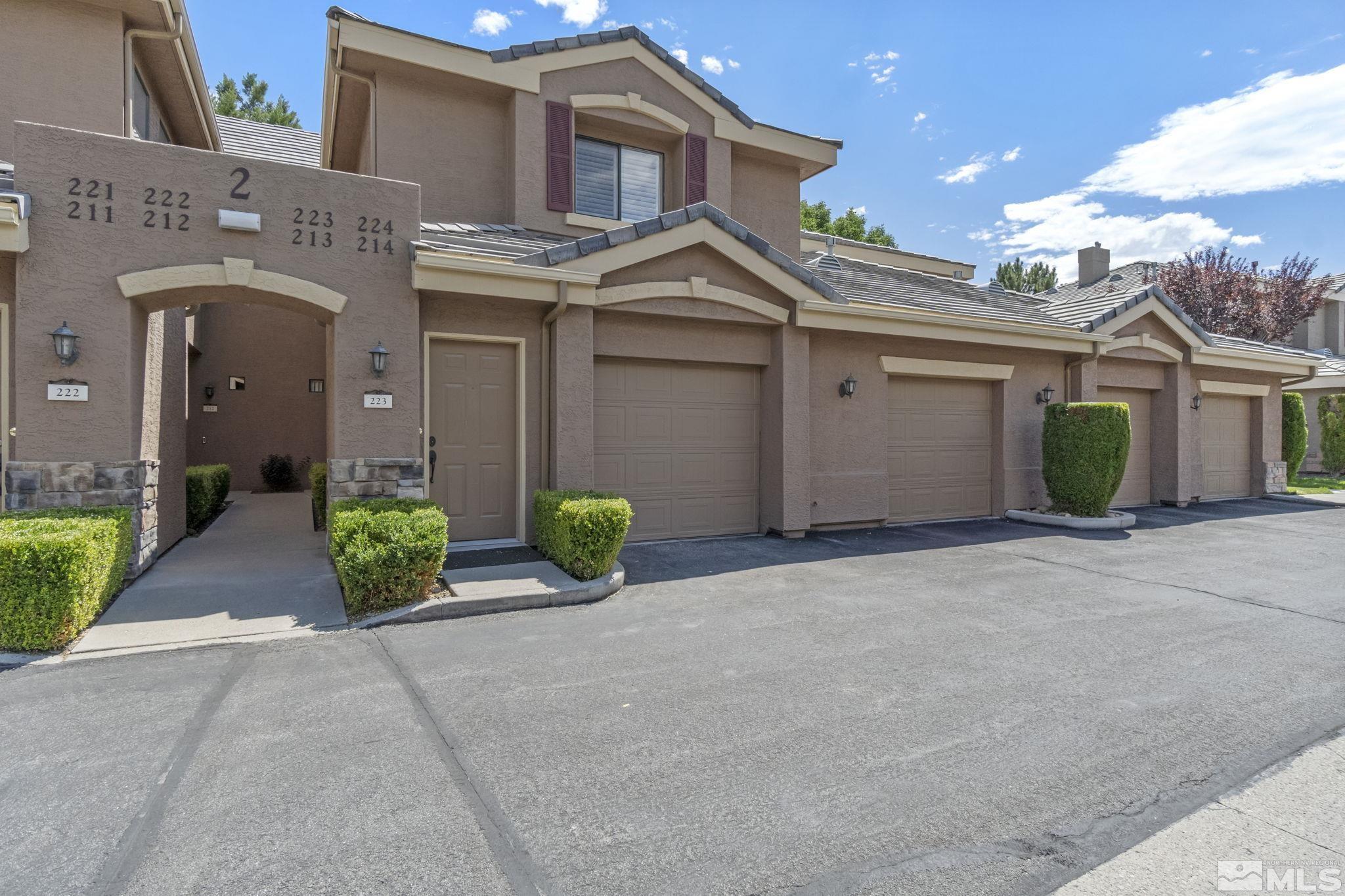 a view of a house with a garage and yard