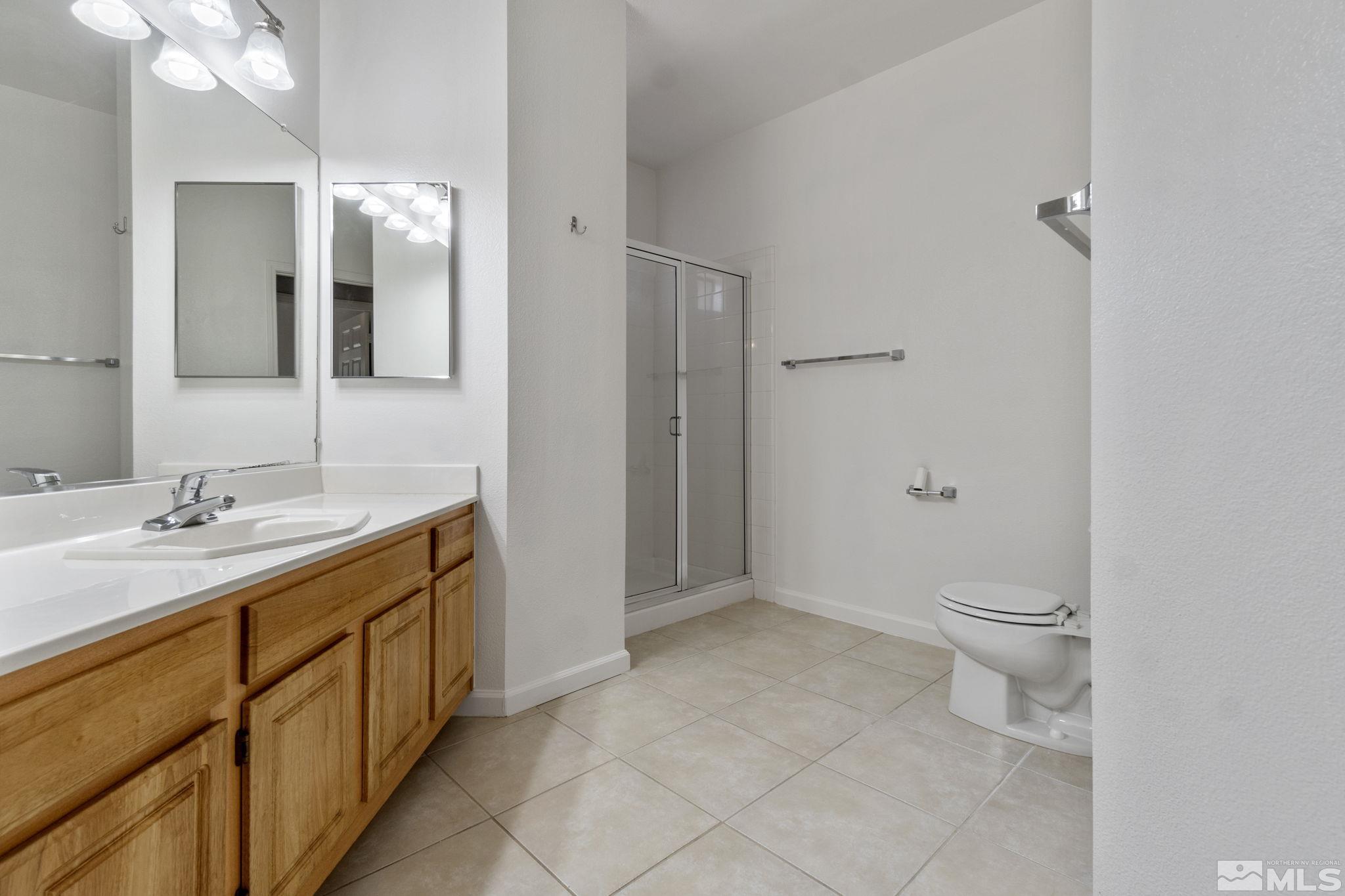 900 South Meadows Parkway, Unit 223 Reno, NV 89521 - Photo 20 of 40 a spacious bathroom with a granite countertop sink toilet and shower