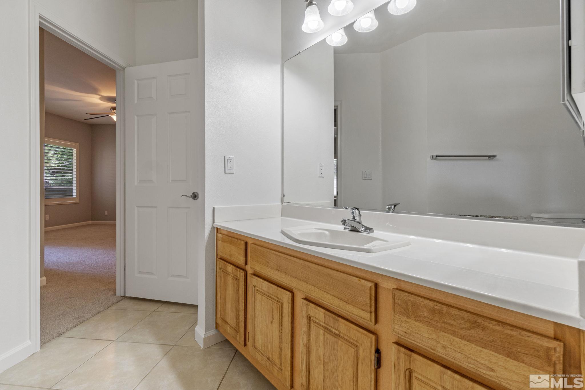 900 South Meadows Parkway, Unit 223 Reno, NV 89521 - Photo 21 of 40 a bathroom with a sink and a mirror