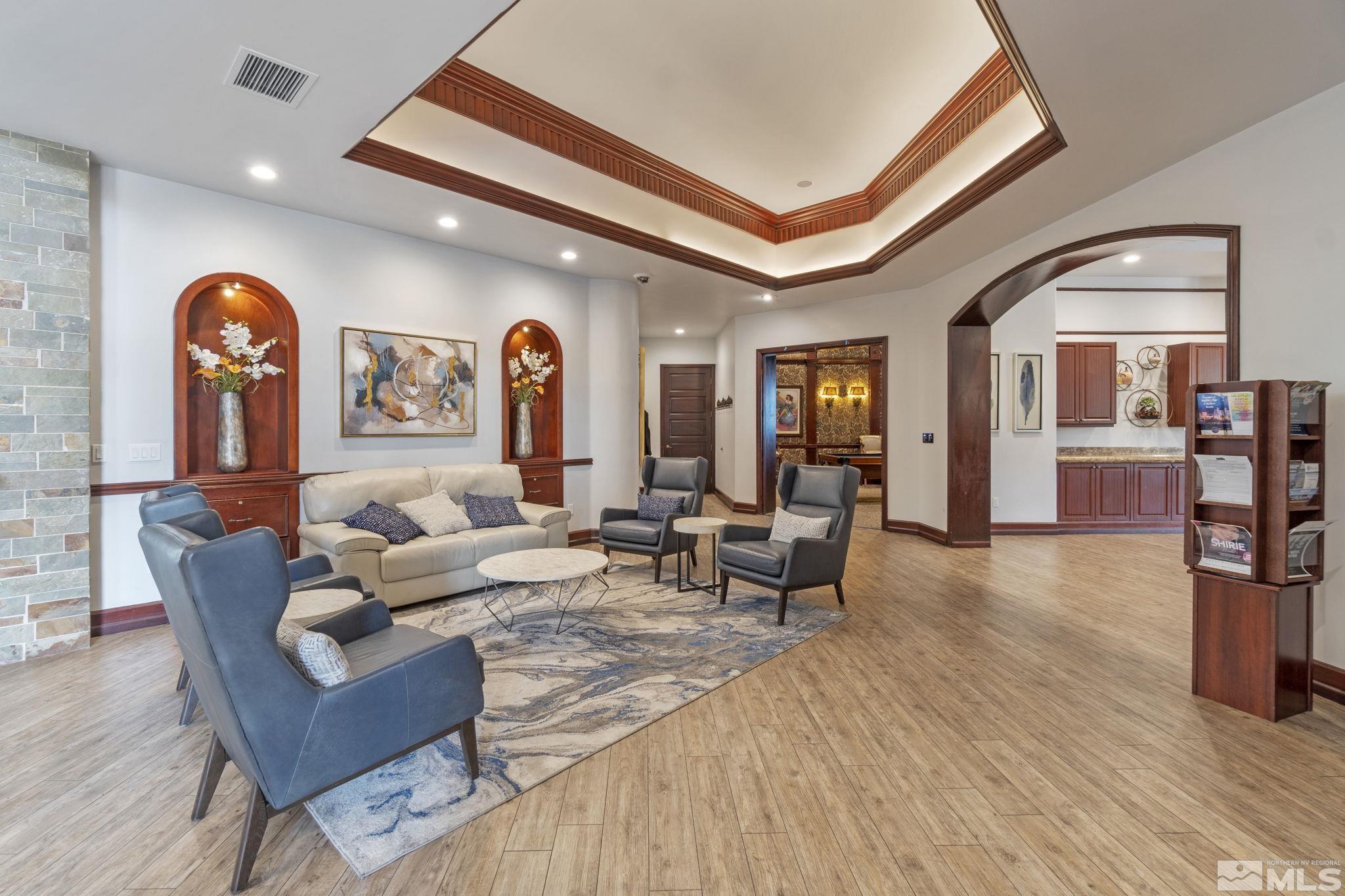 900 South Meadows Parkway, Unit 223 Reno, NV 89521 - Photo 29 of 40 a living room with furniture and a wooden floor