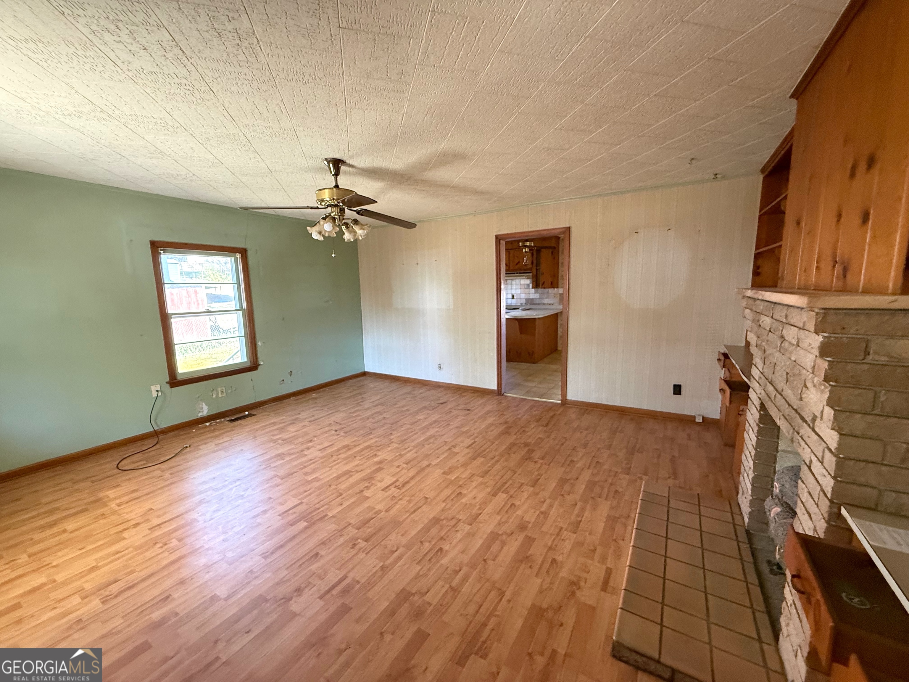 3 Liberty Street Gainesville, GA 30501 - Photo 3 of 8 a view of a livingroom with wooden floor a ceiling fan and windows