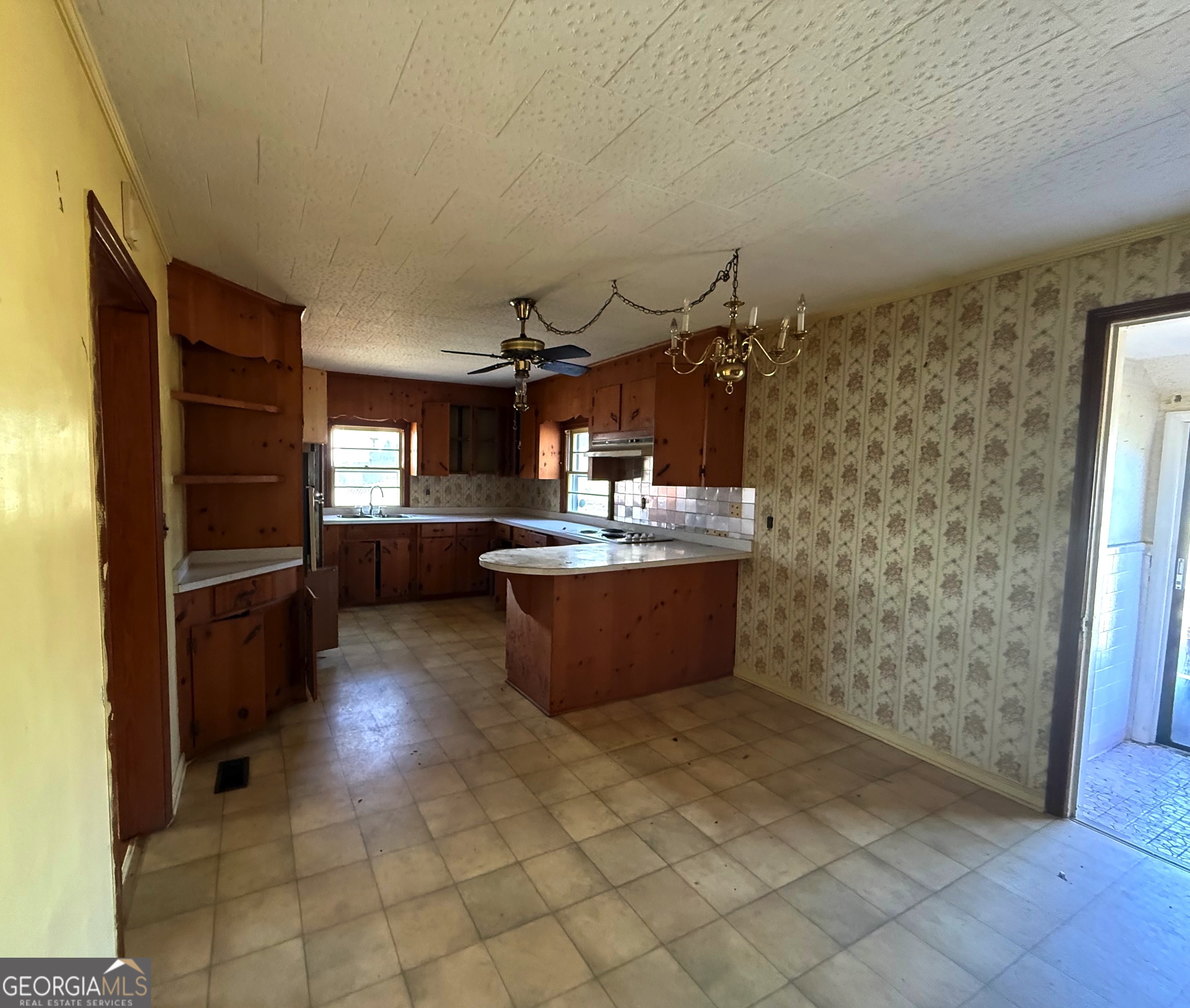 3 Liberty Street Gainesville, GA 30501 - Photo 5 of 8 a kitchen with stainless steel appliances kitchen island granite countertop a refrigerator and a sink