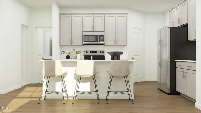 a kitchen with stainless steel appliances kitchen island granite countertop a dining table chairs and a refrigerator