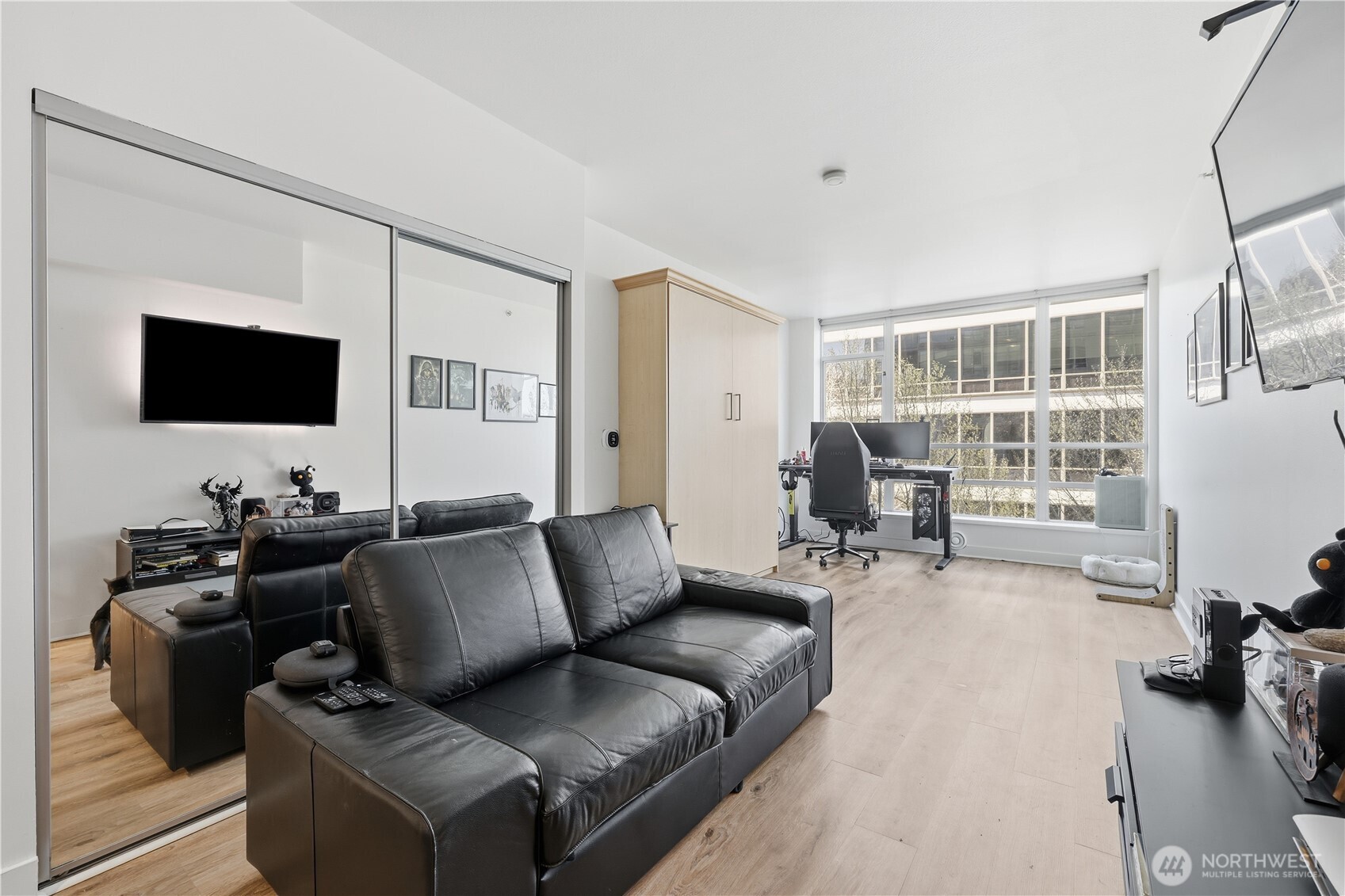 2929 1st Avenue, Unit 201 Seattle, WA 98121 - Photo 15 of 35 a living room with furniture and a flat screen tv