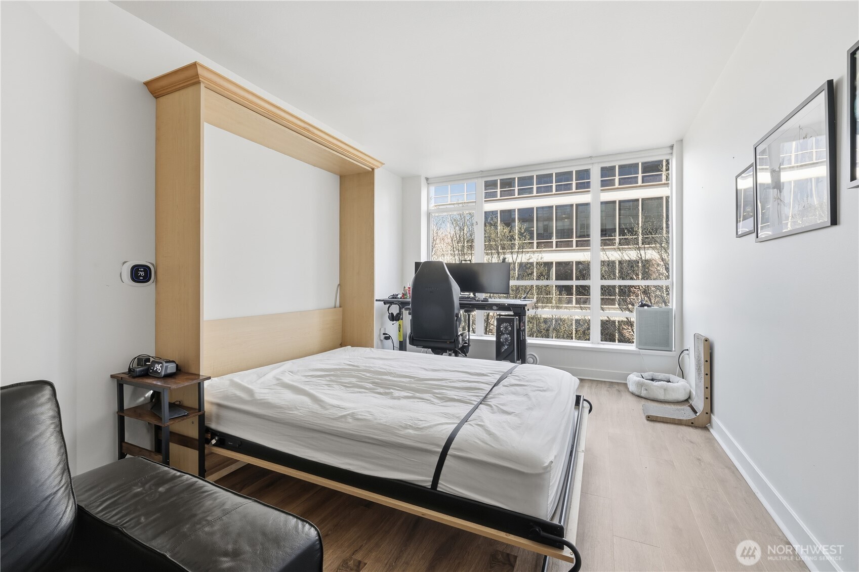 2929 1st Avenue, Unit 201 Seattle, WA 98121 - Photo 4 of 35 a bedroom with a bed a table and windows