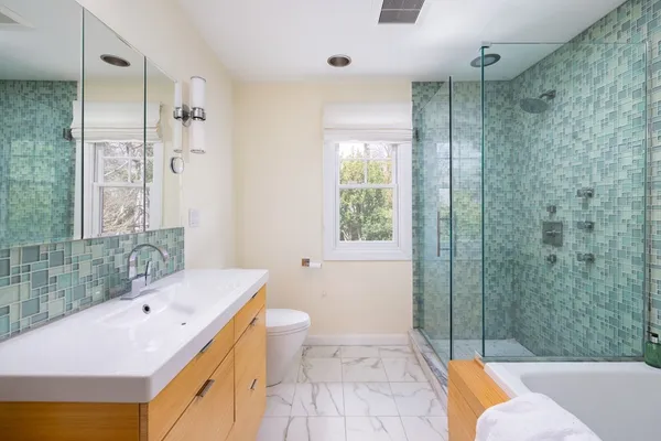 a bathroom with a sink toilet and shower