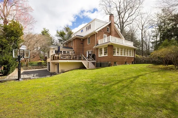 a view of house with yard and sitting area
