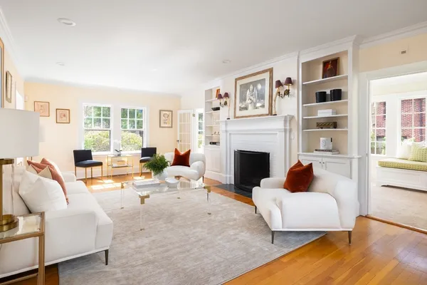 a living room with furniture fireplace and a window