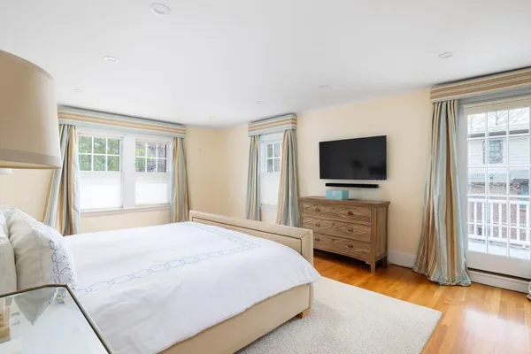 a bedroom with a flat screen television and a bed