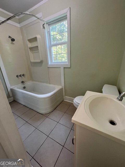 103 Grady Street Thomson, GA 30824 - Photo 16 of 27 a white bath tub sitting in a bathroom next to a window