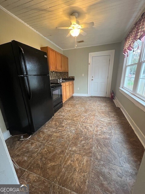 103 Grady Street Thomson, GA 30824 - Photo 21 of 27 a view of a refrigerator in kitchen and wooden floor
