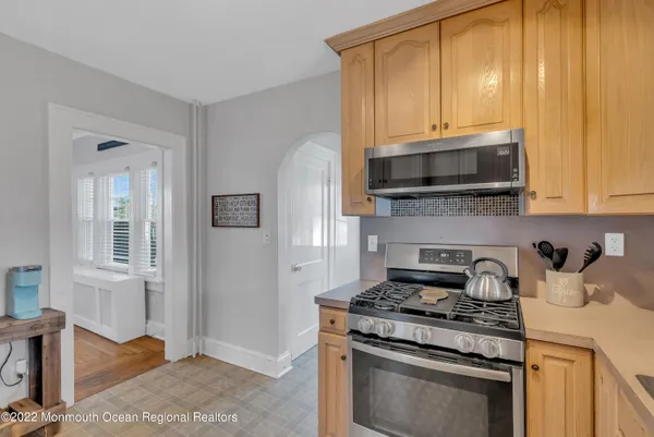 a kitchen with stainless steel appliances granite countertop a stove microwave and cabinets