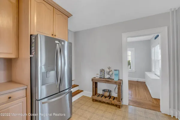 a kitchen with refrigerator and table