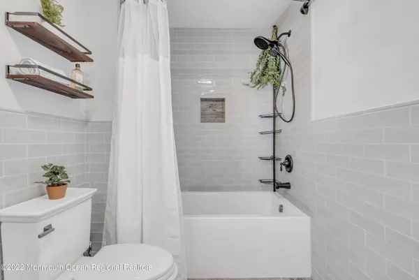 a bath room with a toilet and a bath tub