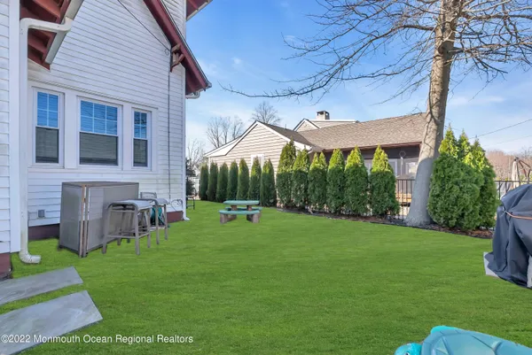 a view of a house with a backyard