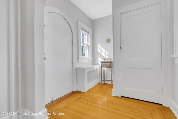 a view of a bedroom with wooden floor and cabinet