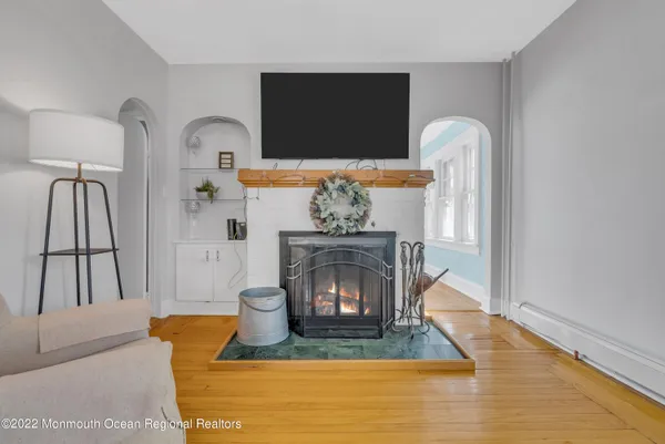 a living room with furniture a flat screen tv and a fireplace