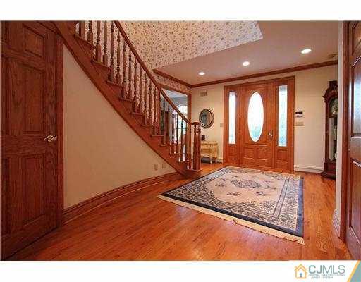 715 Old Raritan Road Edison, NJ 08820 - Photo 2 of 22 a view of a hallway with wooden floor and entryway