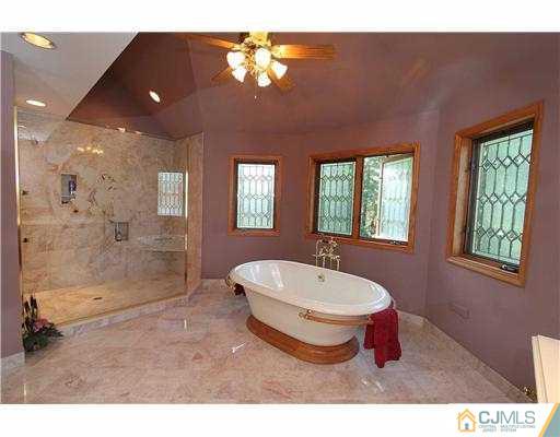 715 Old Raritan Road Edison, NJ 08820 - Photo 12 of 22 a spacious bathroom with a bathtub shower sink and mirror