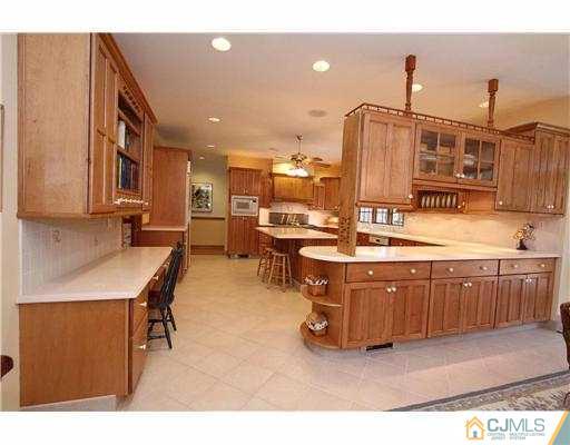 715 Old Raritan Road Edison, NJ 08820 - Photo 6 of 22 a kitchen with stainless steel appliances kitchen island granite countertop a sink and cabinets